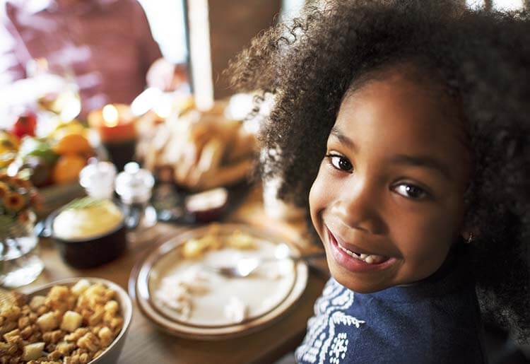 Small child enjoying dinnertime with meal kit Small child enjoying dinnertime with meal kit