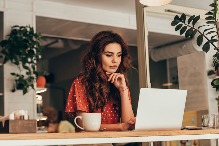 Lady looking at screen thinking about her website Lady looking at screen thinking about her website