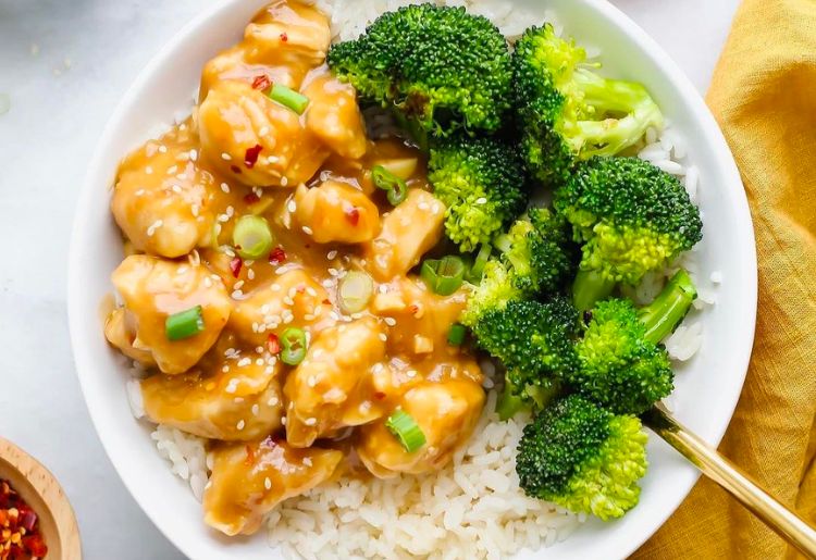 Organic broccoli and spicy chicken stir fry over rice