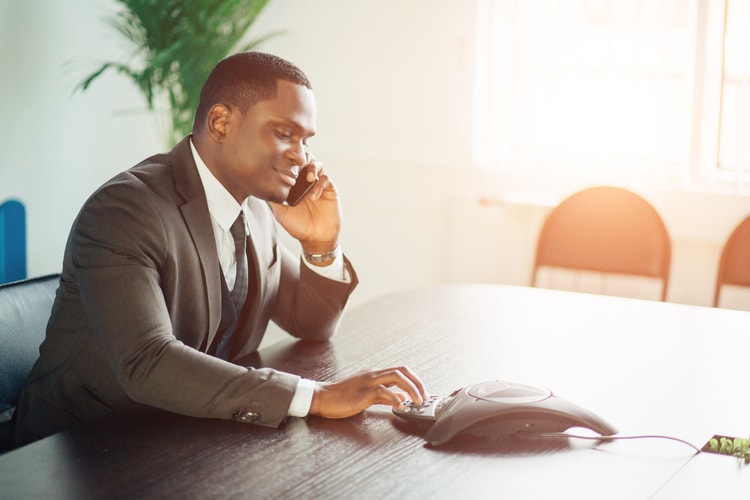 Powerful man on VoIP business call Powerful man on VoIP business call